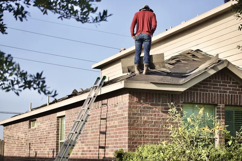 Professional roofer working on a residential roof in Sheldon Charter Oak